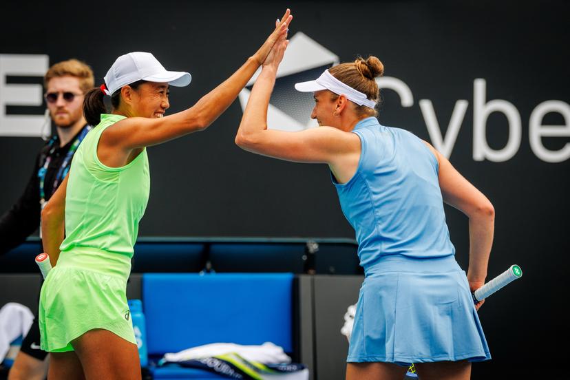 Belgian Elise Mertens (R) and her Chinese partner Shuai Peng celebrate during a doubles tennis match against Taiwanese-Japanese pair Wu-Hozumi, in the quarterfinals of the women doubles at the Australian Open, Melbourne Park, Melbourne on Wednesday 28 January 2026. Mertens - Zhang won the game. BELGA PHOTO PATRICK HAMILTON --- BENELUX ONLY ---