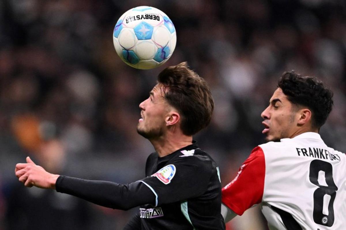 Bremen's Belgian midfielder #02 Olivier Deman (L) vies for the ball with Frankfurt's Algerian midfielder #08 Fares Chaibi during the German first division Bundesliga football match between Eintracht Frankfurt and Werder Bremen in Frankfurt am Main, western Germany on November 23, 2024. Kirill KUDRYAVTSEV / AFP