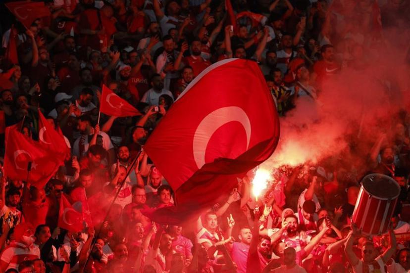 Turkey fans light flares and some make the controversial hand gesture associated with Turkish right-wing extremist group Grey Wolves during the UEFA Euro 2024 quarter-final football match between the Netherlands and Turkey at the Olympiastadion in Berlin on July 6, 2024. Odd ANDERSEN / AFP