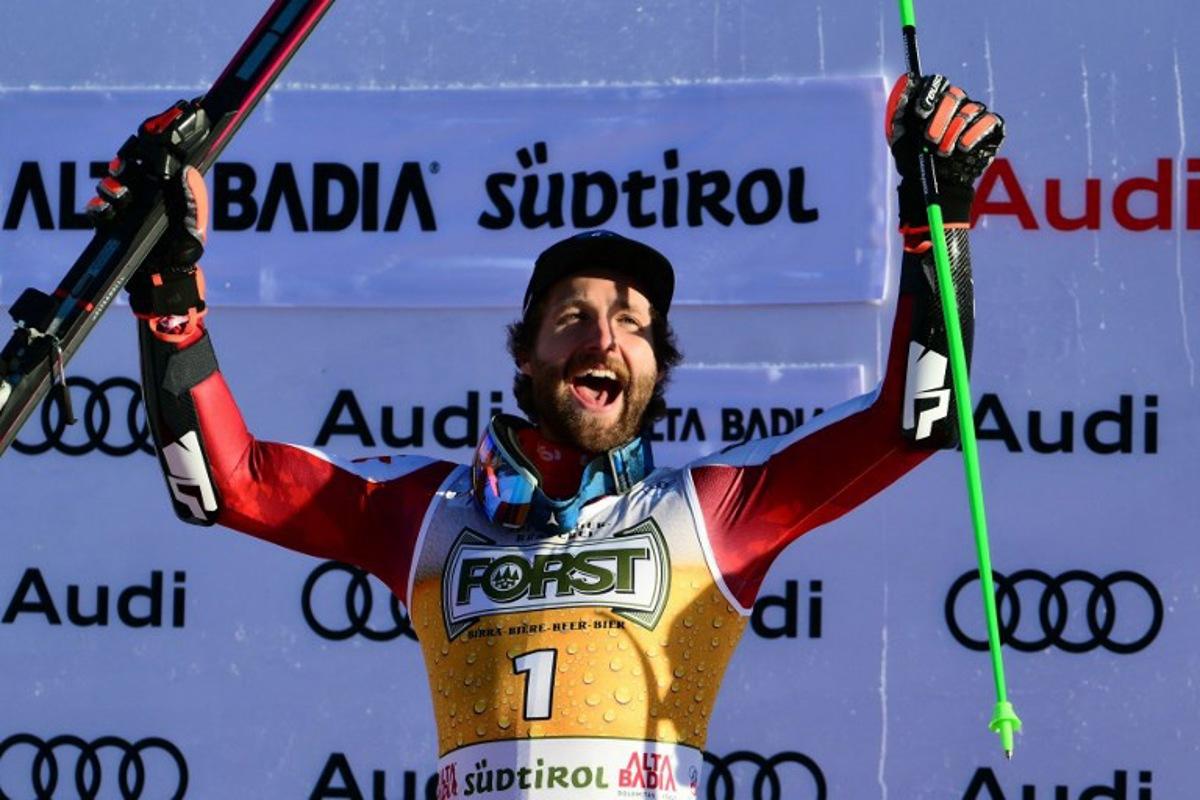 Race winner Austria's Marco Schwarz celebrates on the podium after competing in the men's giant slalom part of the FIS Alpine Ski World Cup 2025-2026, in Alta Badia, northern Italy, on December 21, 2025. Stefano RELLANDINI / AFP