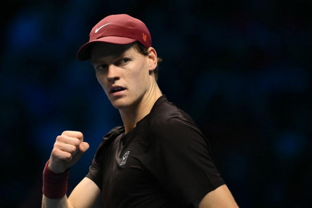 Italy's Jannik Sinner celebrates after winning the first set against Australia's Alex De Minaur at the ATP Finals tennis tournament in Turin on November 15, 2025. Marco BERTORELLO / AFP