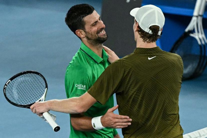 Serbia's Novak Djokovic greets Italy's Jannik Sinner after winning their men's singles semi-final match on day thirteen of the Australian Open tennis tournament in Melbourne on January 31, 2026. WILLIAM WEST / AFP